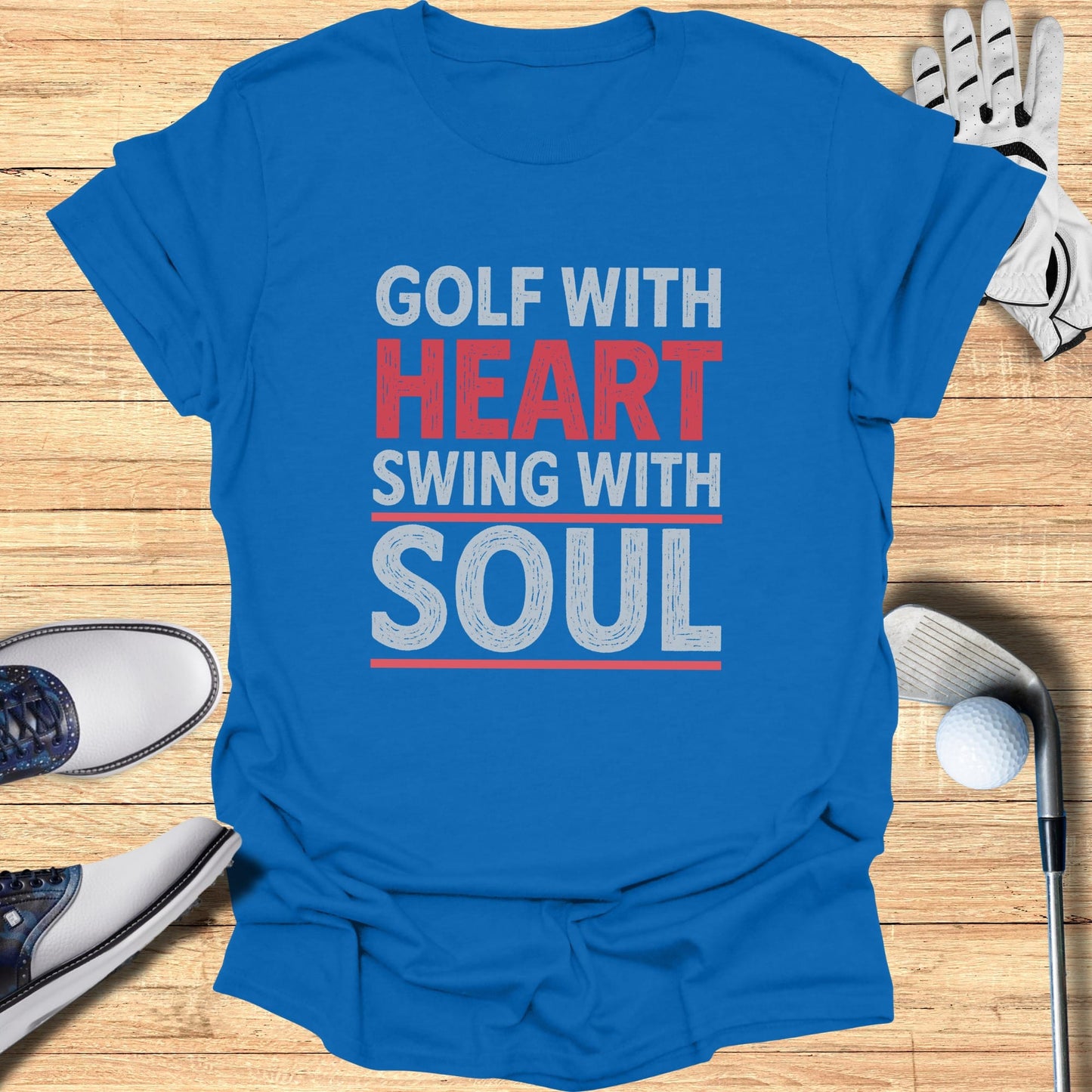 Blue t-shirt with "GOLF WITH HEART SWING WITH SOUL" text.