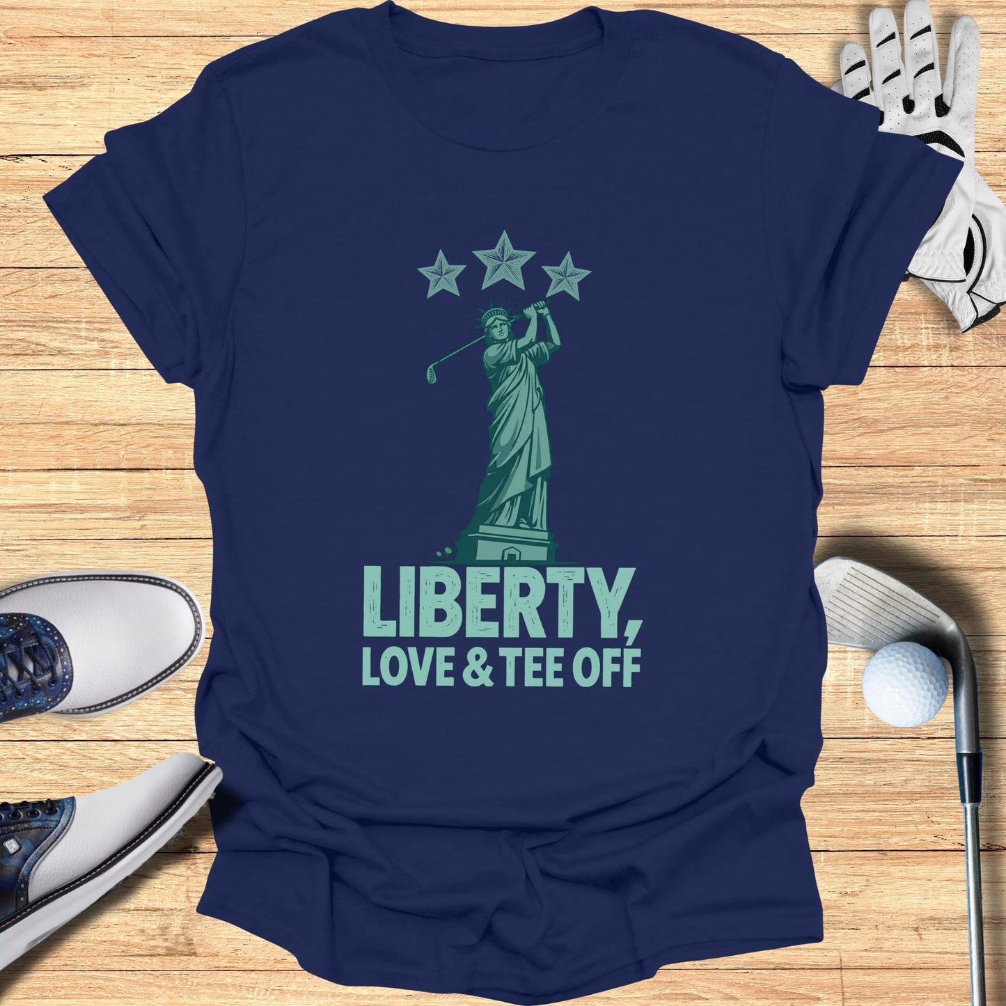 Navy t-shirt featuring the Statue of Liberty, golf club, and "Liberty, Love & Tee Off" text.