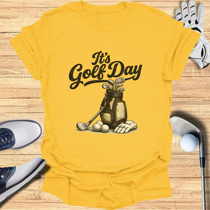 Yellow t-shirt with "It's Golf Day" text and golf bag illustration.