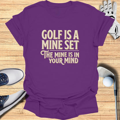 Purple t-shirt with "Golf is a mine set the mine is in your mind" text.