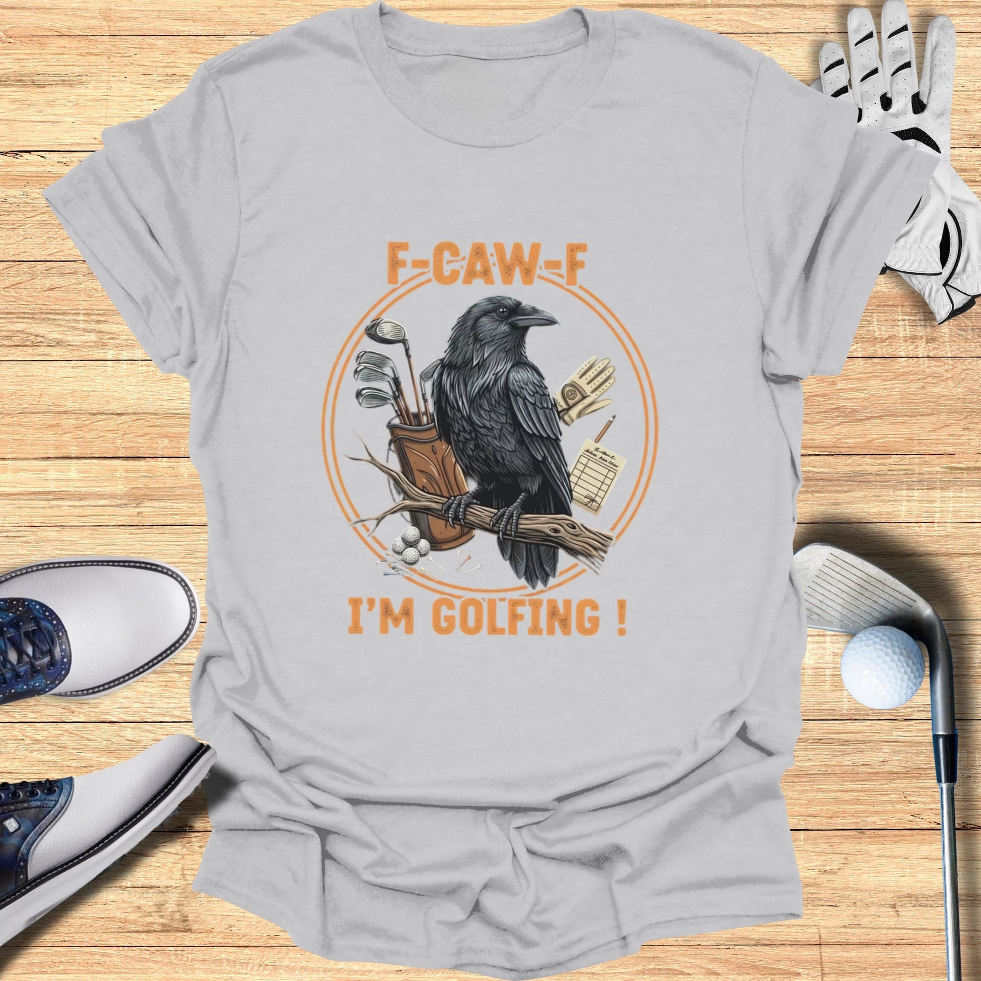 T-shirt graphic of a raven with golf clubs and a scorecard.