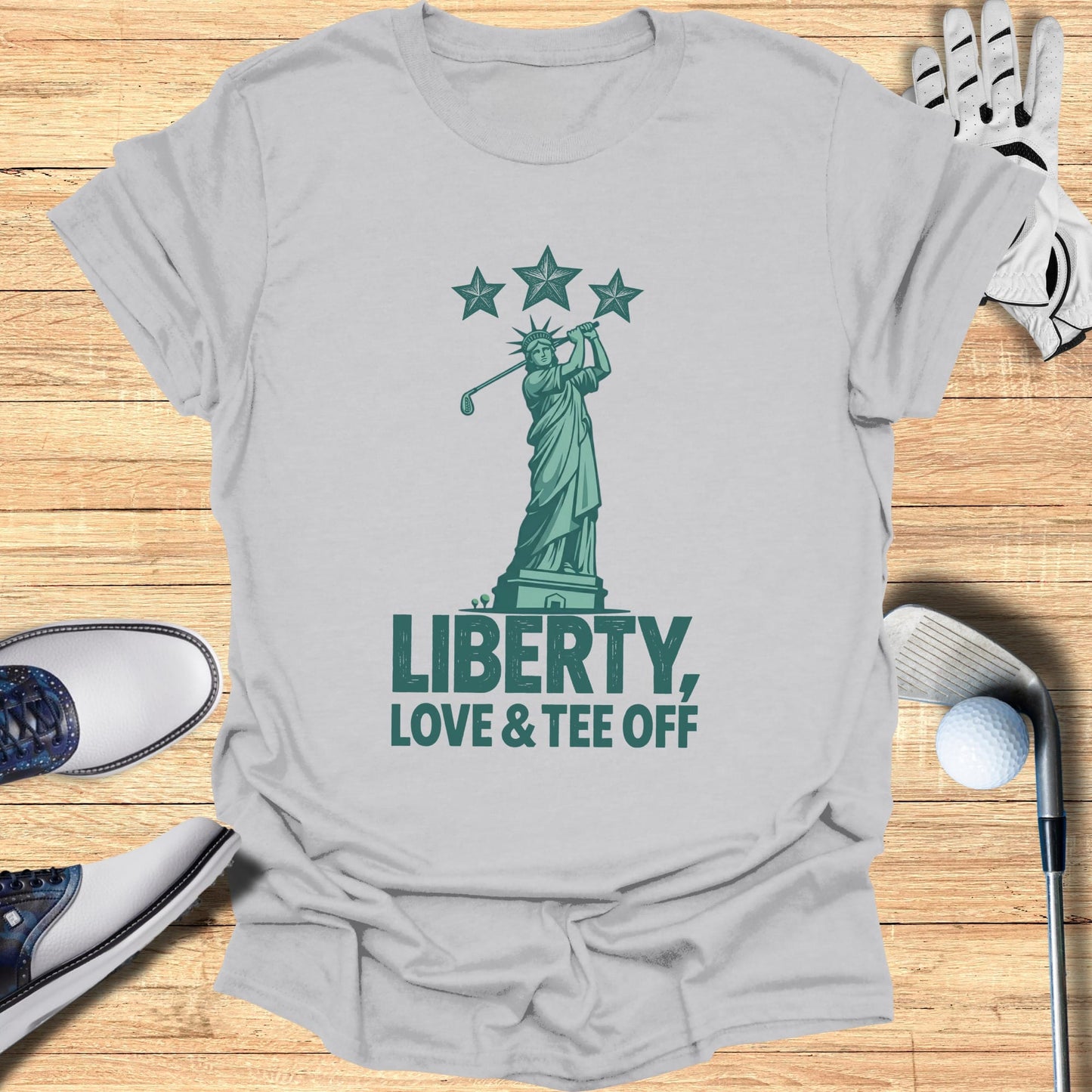 Statue of Liberty swings golf club under stars, text LIBERTY, LOVE & TEE OFF.
