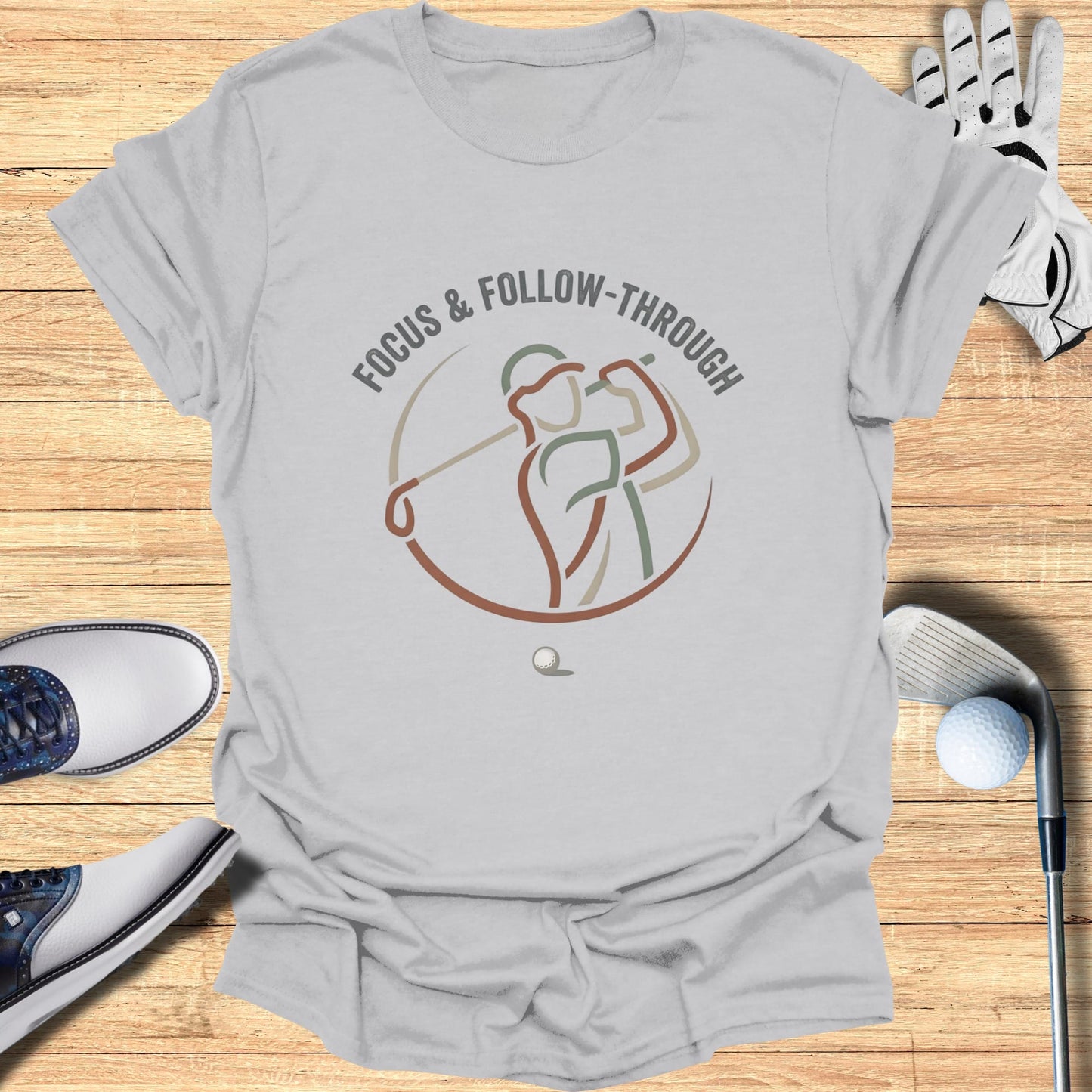 Gray t-shirt with a minimalist golf swing graphic and text "FOCUS & FOLLOW-THROUGH".