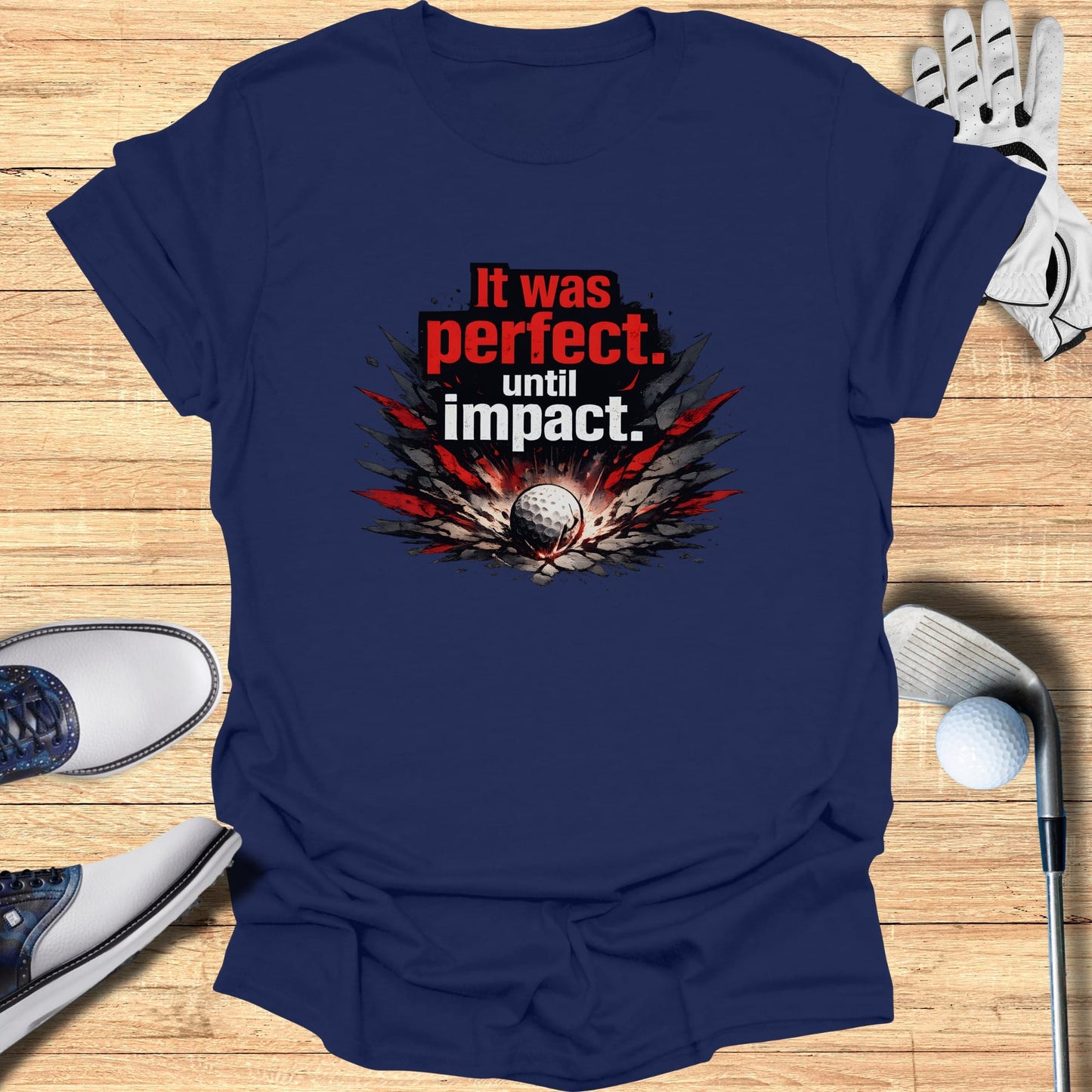 Navy t-shirt with "It was perfect, until impact." text and golf ball graphic.