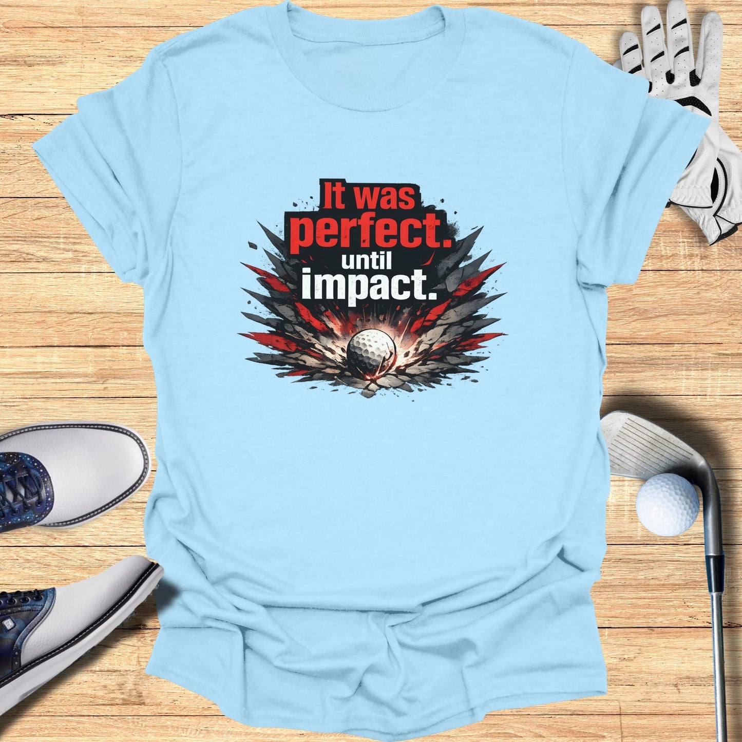 Light blue t-shirt with "It was perfect. until impact." golf ball graphic.