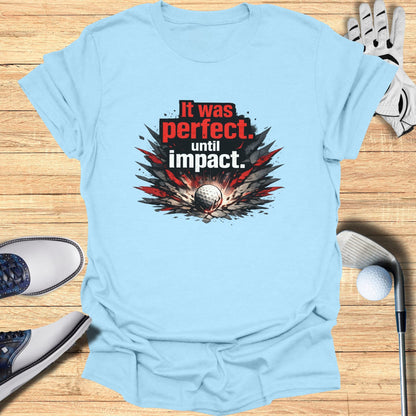 Light blue t-shirt with "It was perfect. until impact." golf ball graphic.
