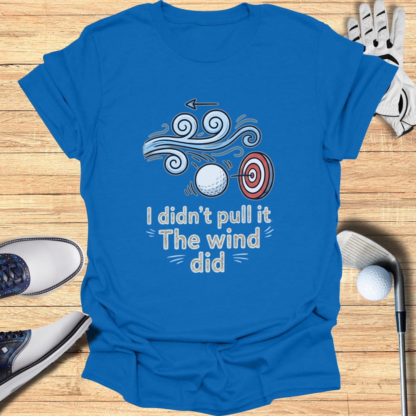 Blue t-shirt with "I didn't pull it The wind did" text and golf imagery.