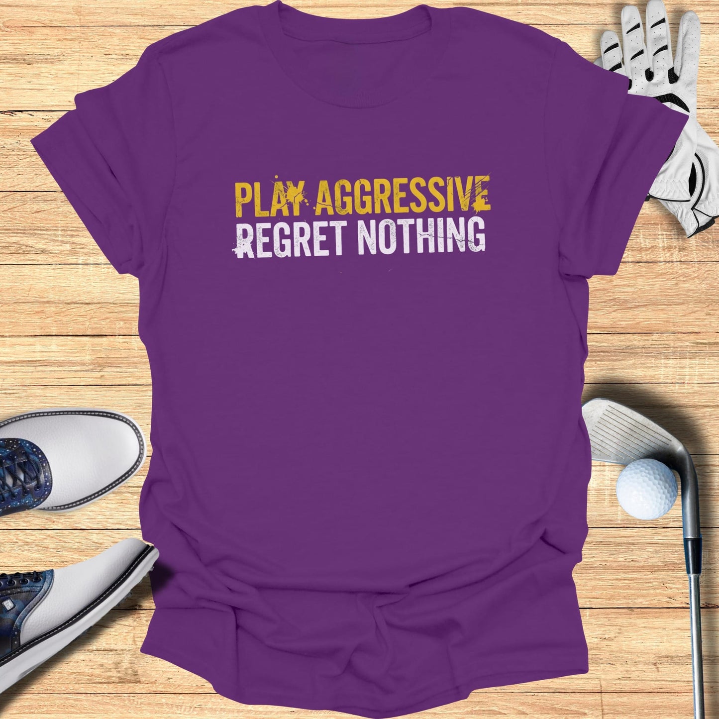 Purple t-shirt with "PLAY AGGRESSIVE REGRET NOTHING" text.