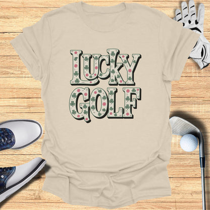 Lucky Golf text on a tan t-shirt with golf accessories.