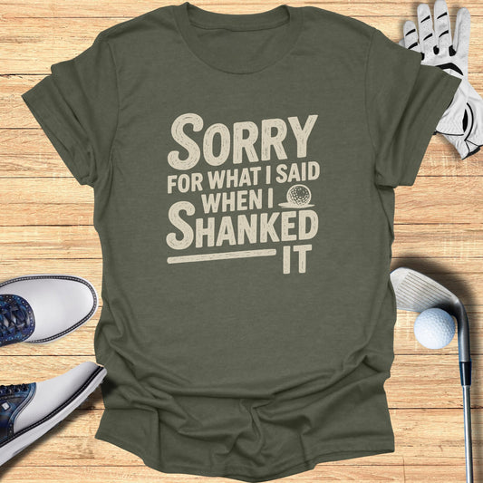 Olive t-shirt with "SORRY WHEN I SHANKED IT" text and golf accessories.