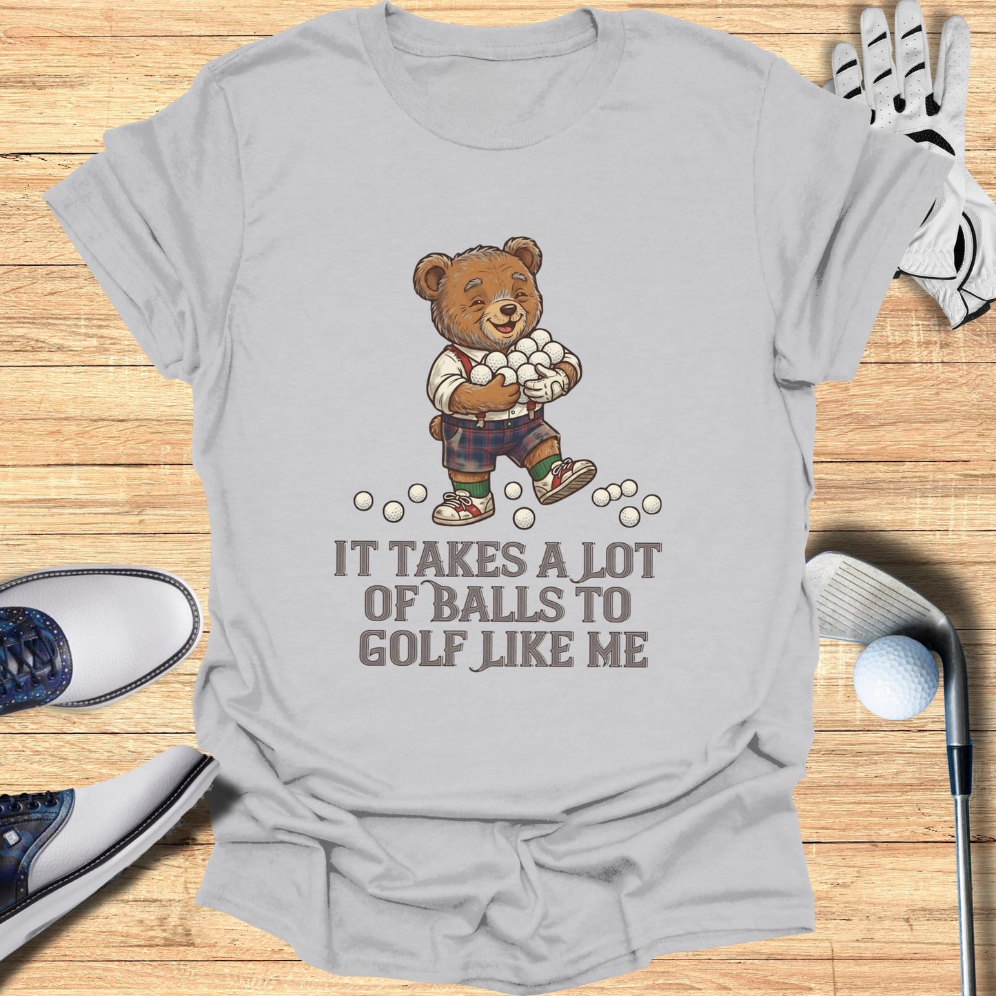 Bear in plaid shorts carries golf balls with "It takes a lot of balls to golf like me" text.