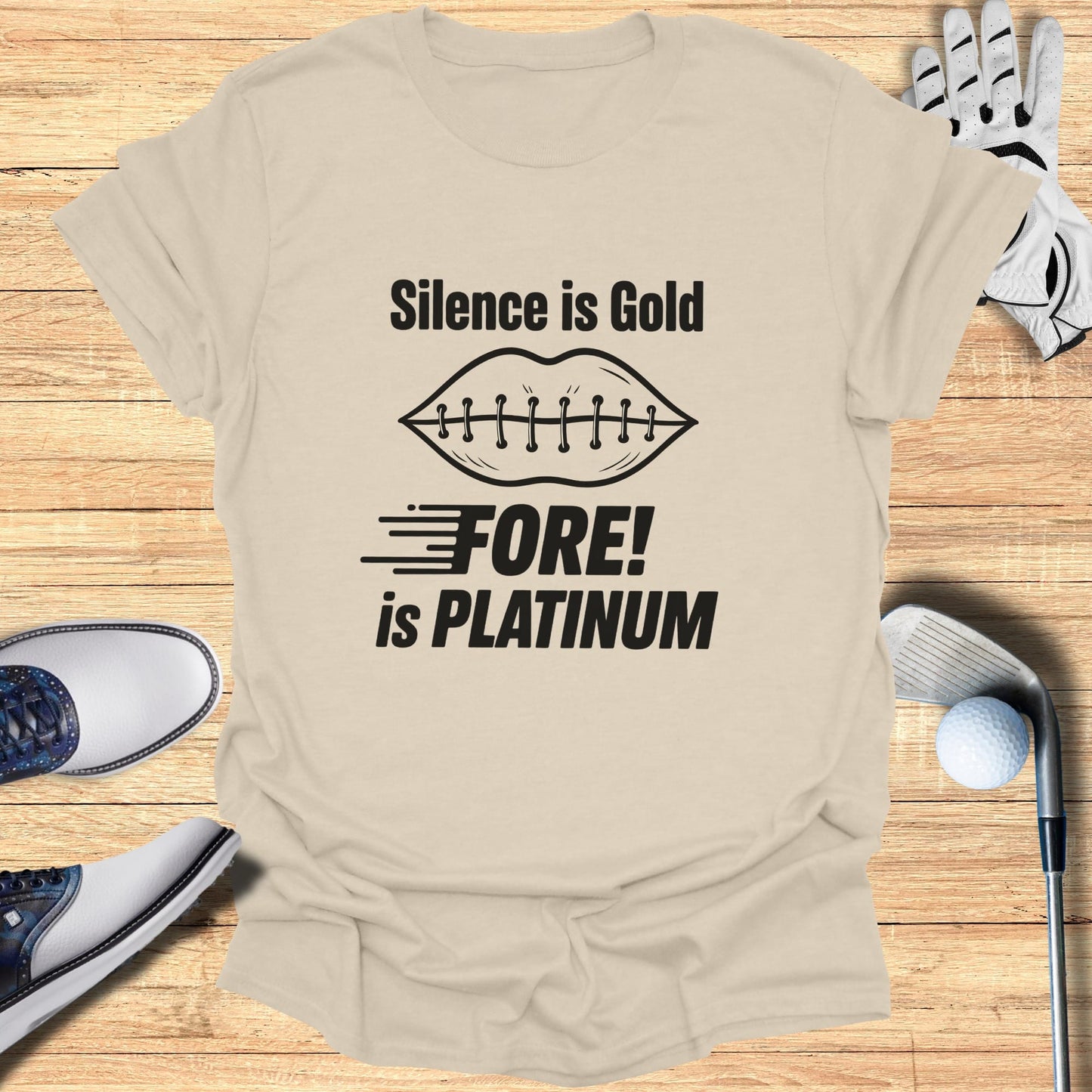 Tan t-shirt with "Silence is Gold, Fore! is Platinum" text and golf accessories.