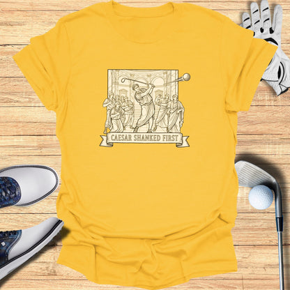 Yellow t-shirt with a black line drawing of Caesar at a golf game.