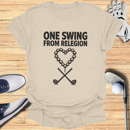 T-shirt with "ONE SWING FROM RELEGION" and crossed golf clubs inside a heart of golf balls.