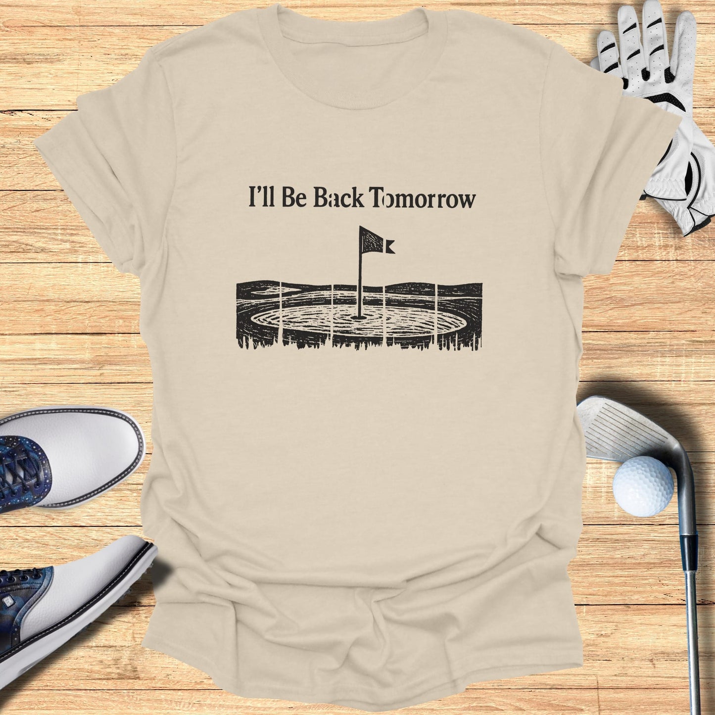 T-shirt with "I'll Be Back Tomorrow" text and golf course graphic.