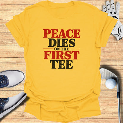 Yellow t-shirt with "Peace Dies On The First Tee" text, golf clubs and shoes.