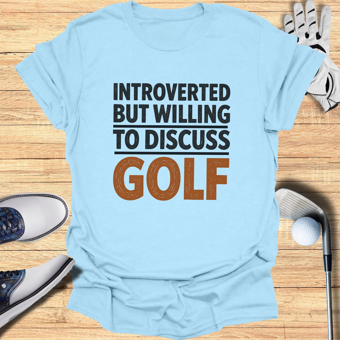 Light blue t-shirt with "INTROVERTED BUT WILLING TO DISCUSS GOLF" text.