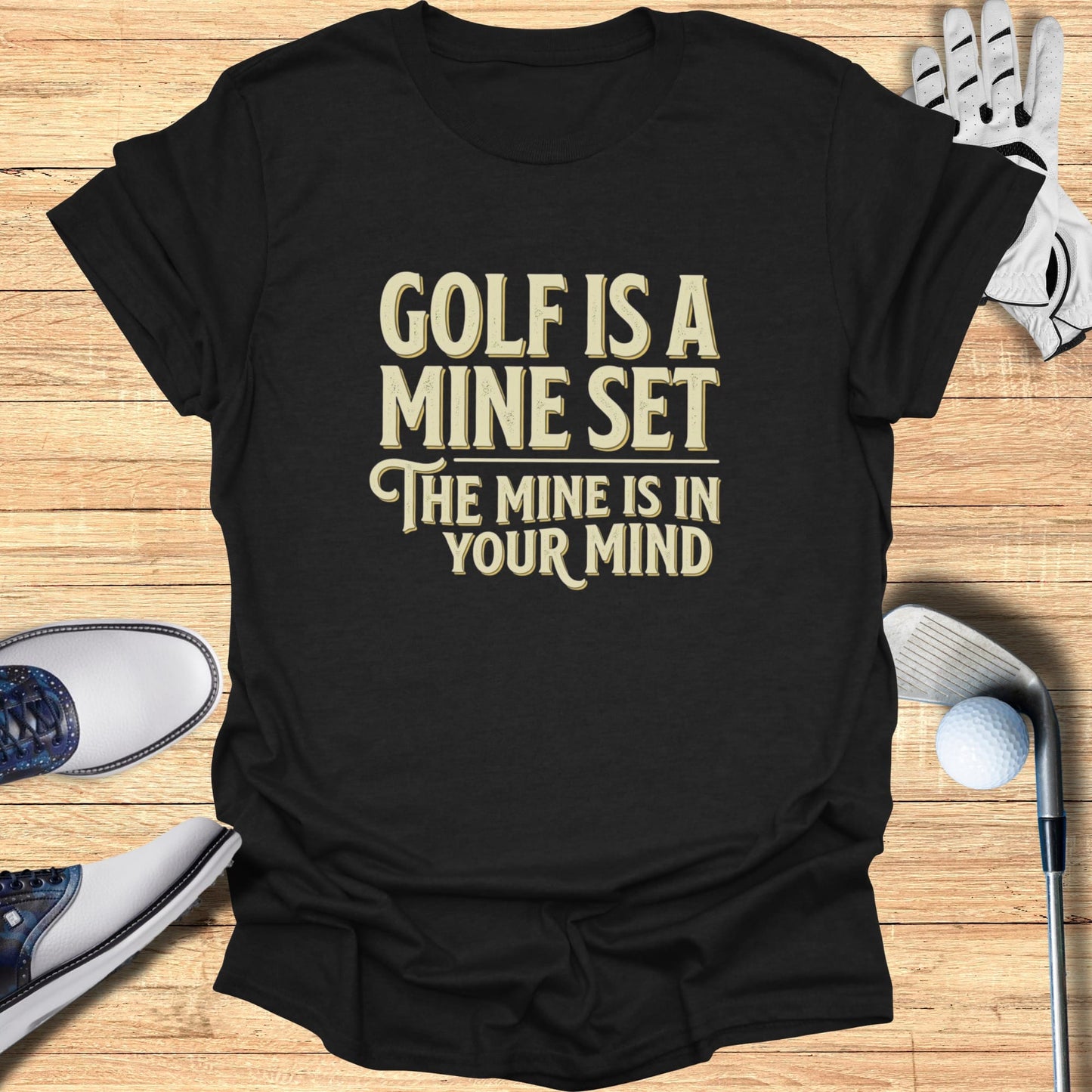 Black t-shirt with white text "GOLF IS A MINE SET THE MINE IS IN YOUR MIND".