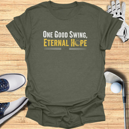Green t-shirt with "One Good Swing, Eternal Hope" text and golf accessories.
