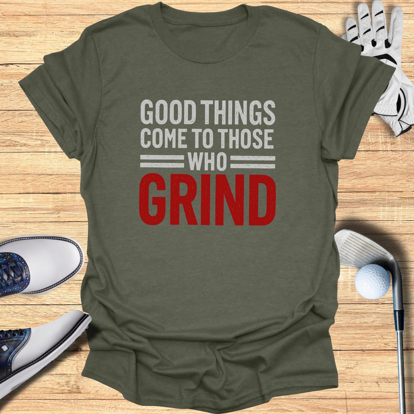 T-shirt with "Good Things Come to Those Who Grind" text and golf accessories.