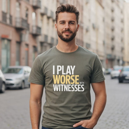 Man wearing olive green t-shirt with text "I PLAY WORSE WITH WITNESSES".