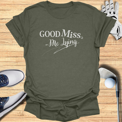 Olive green t-shirt with "Good Miss, Me Lying" text.