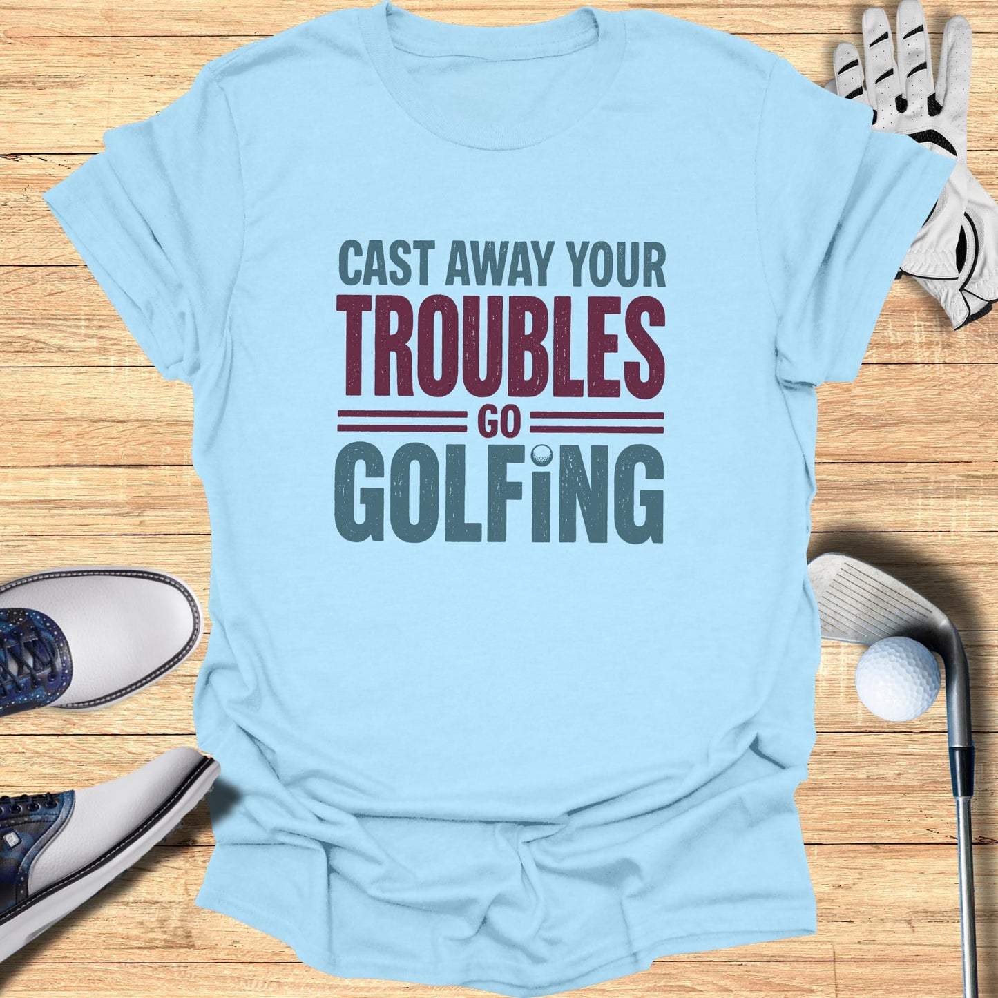 Light blue t-shirt with "Cast Away Your Troubles Go Golfing" text.