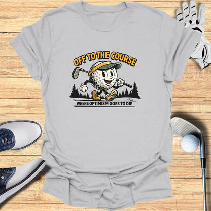 T-shirt with a cartoon golfer and text "OFF TO THE COURSE WHERE OPTIMISM GOES TO DIE".