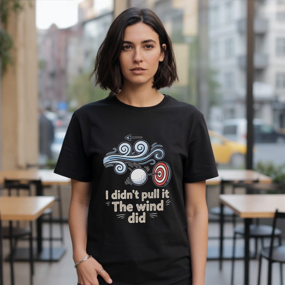 Black t-shirt with "I didn't pull it The wind did" text and golf graphics.