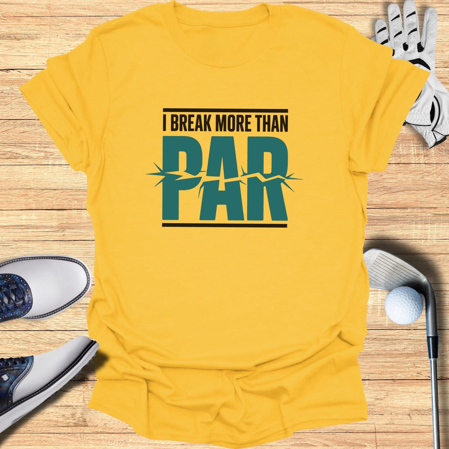 Yellow t-shirt with text "I BREAK MORE THAN PAR" and golf accessories.