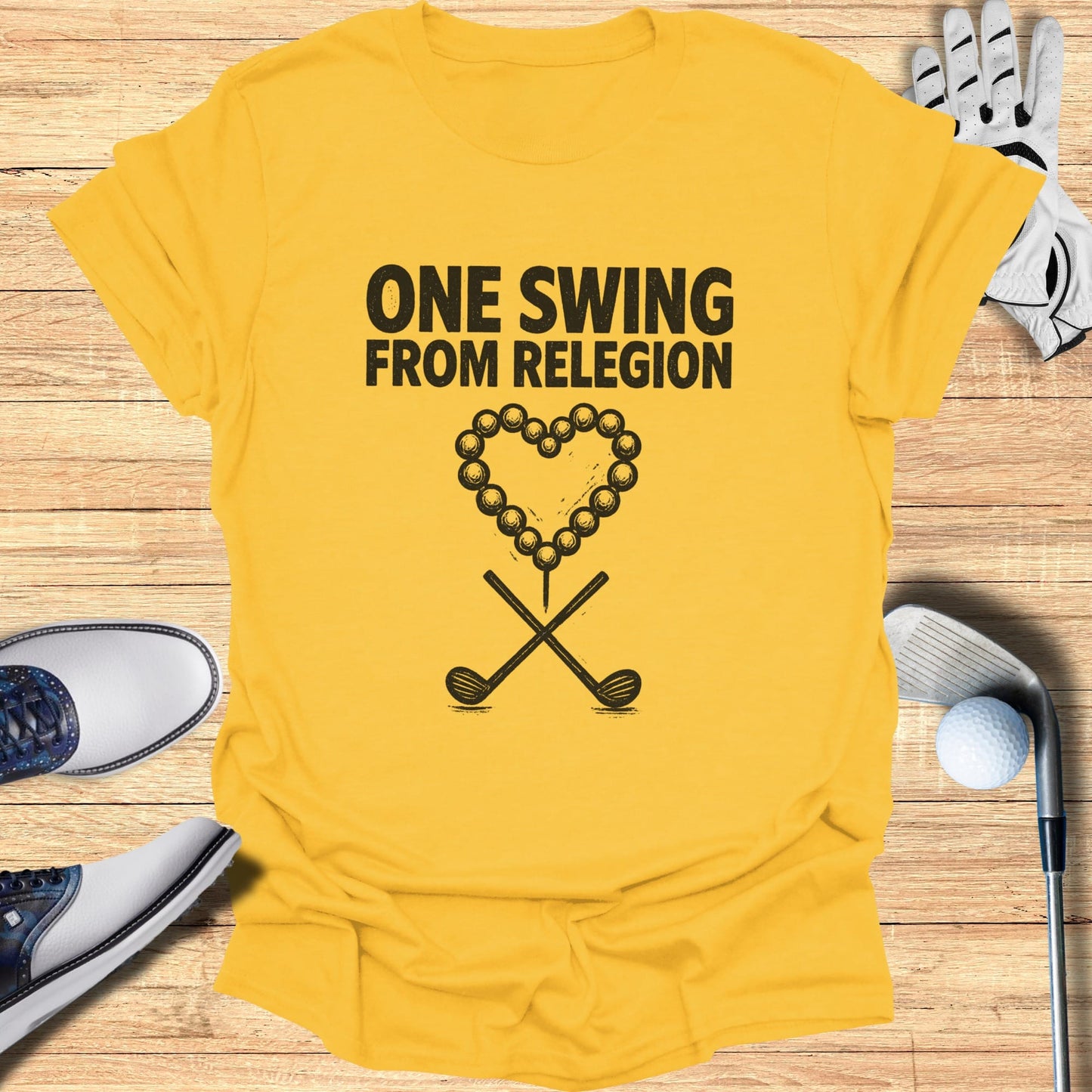 Yellow t-shirt with "ONE SWING FROM RELEGION" and golf heart graphic.