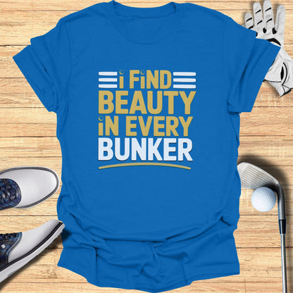 Blue t-shirt with "I FIND BEAUTY IN EVERY BUNKER" text in yellow and white.