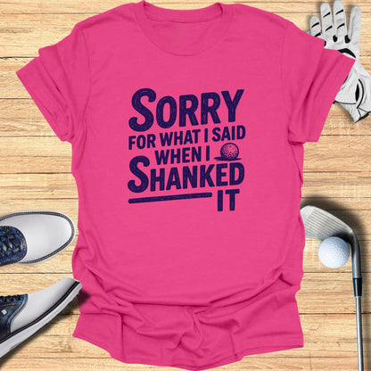 Pink t-shirt with "Sorry for what I said when I shanked it" in dark blue text.