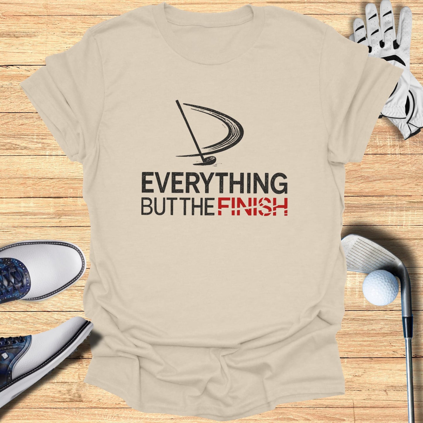 T-shirt with "EVERYTHING BUT THE FINISH" text and golf items.