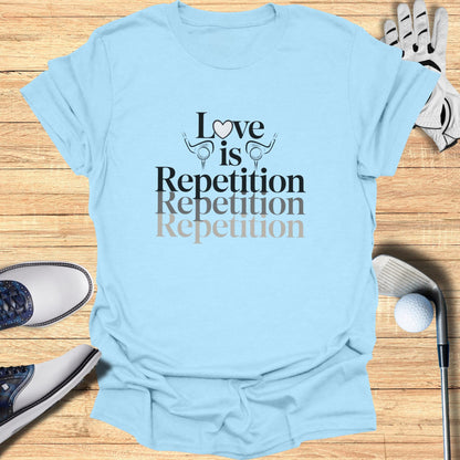 Light blue t-shirt with "Love is Repetition Repetition Repetition" text and golf graphics.
