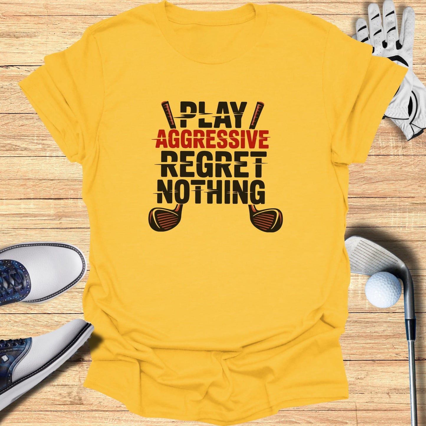 Yellow t-shirt with "PLAY AGGRESSIVE REGRET NOTHING" text and golf clubs.