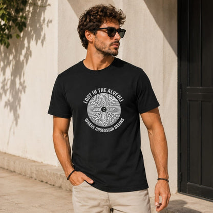 Man wearing black t-shirt with circular maze design and text.