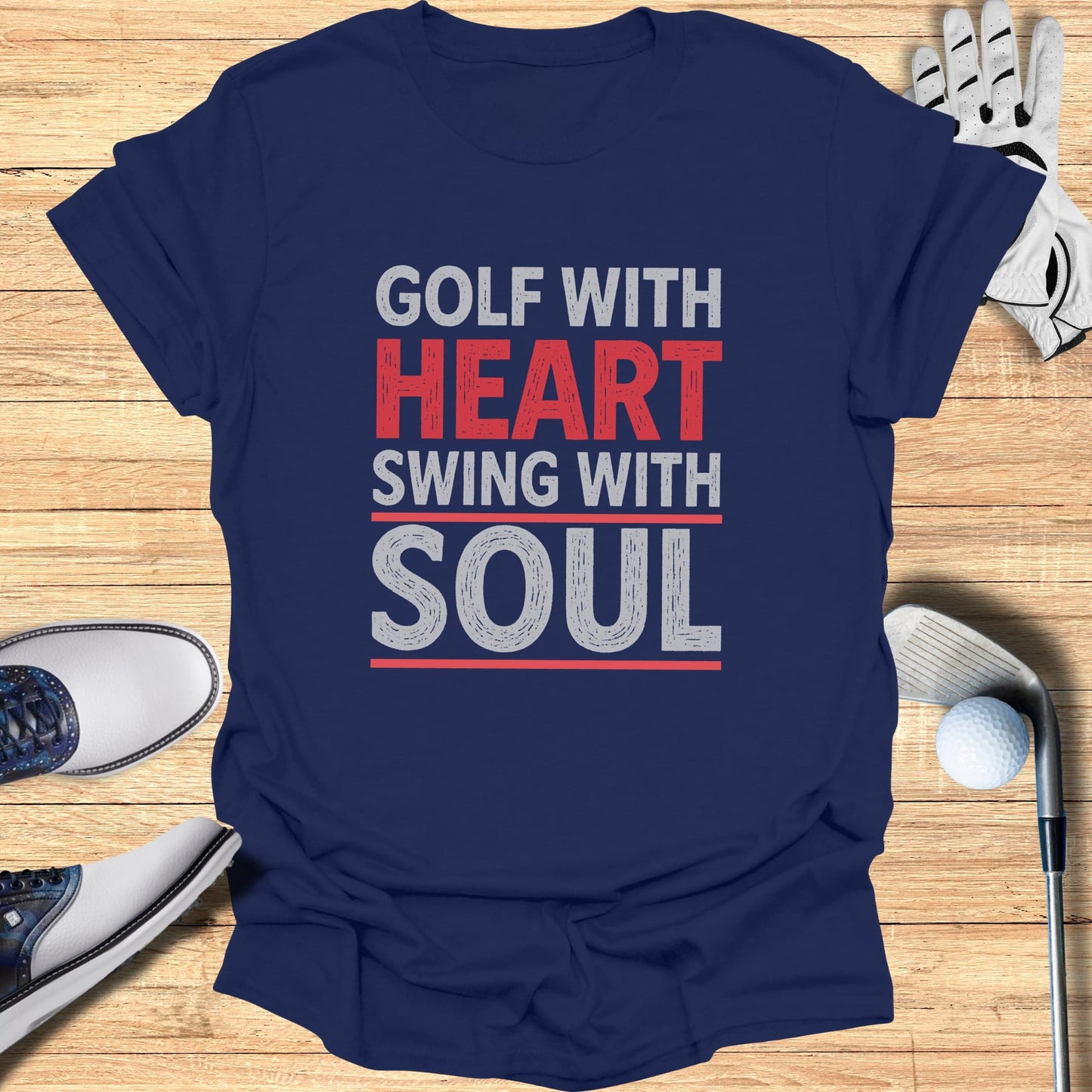 Navy t-shirt with "Golf with Heart Swing with Soul" text, golf shoes, and ball.