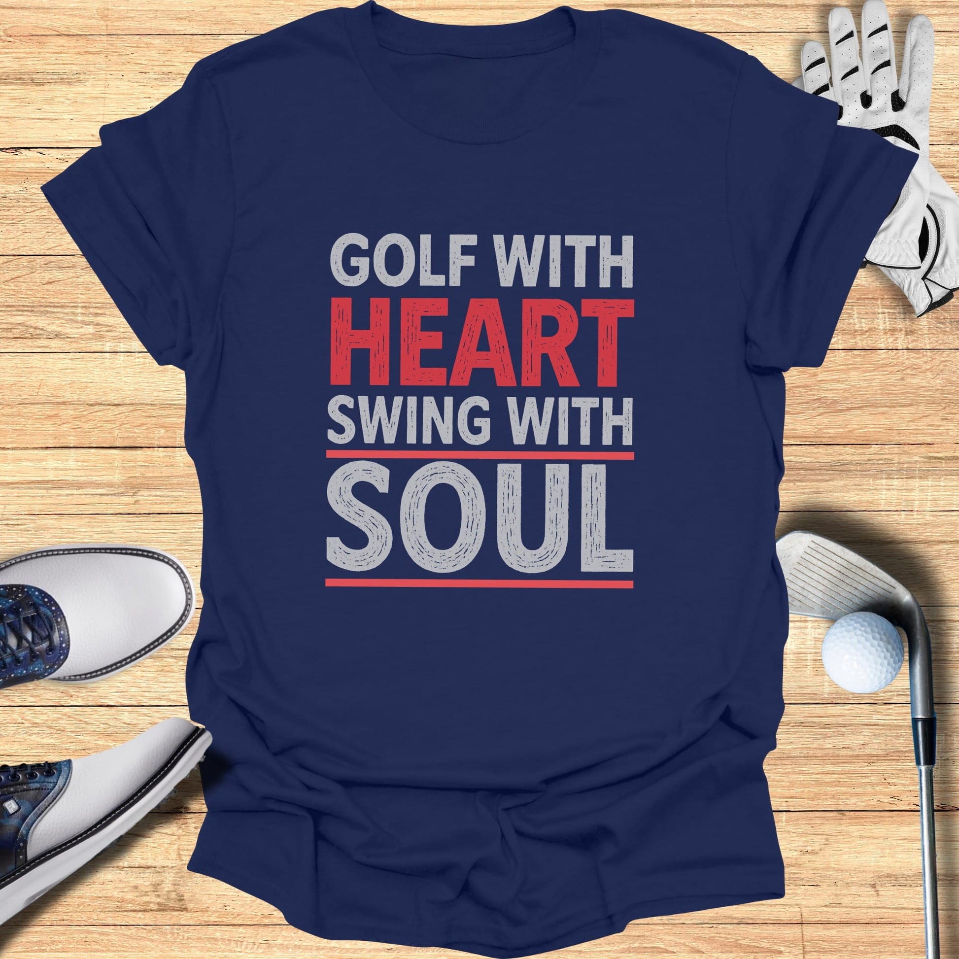 Navy t-shirt with "Golf with Heart Swing with Soul" text, golf shoes, and ball.