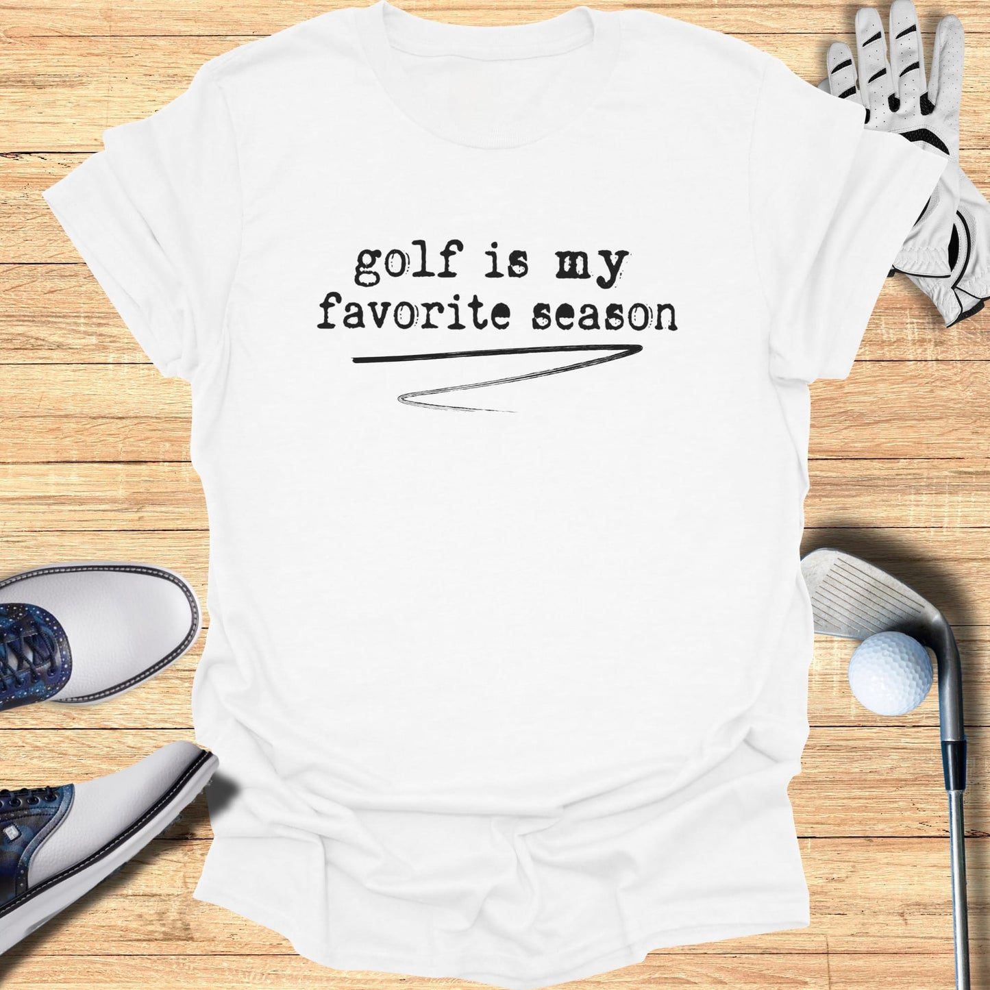 White t-shirt with "golf is my favorite season" printed in black text.