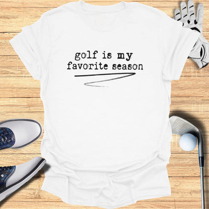 White t-shirt with "golf is my favorite season" printed in black text.