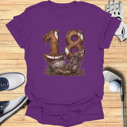 Purple t-shirt with "18" design made of chocolate and dirt, featuring golf clubs and balls.