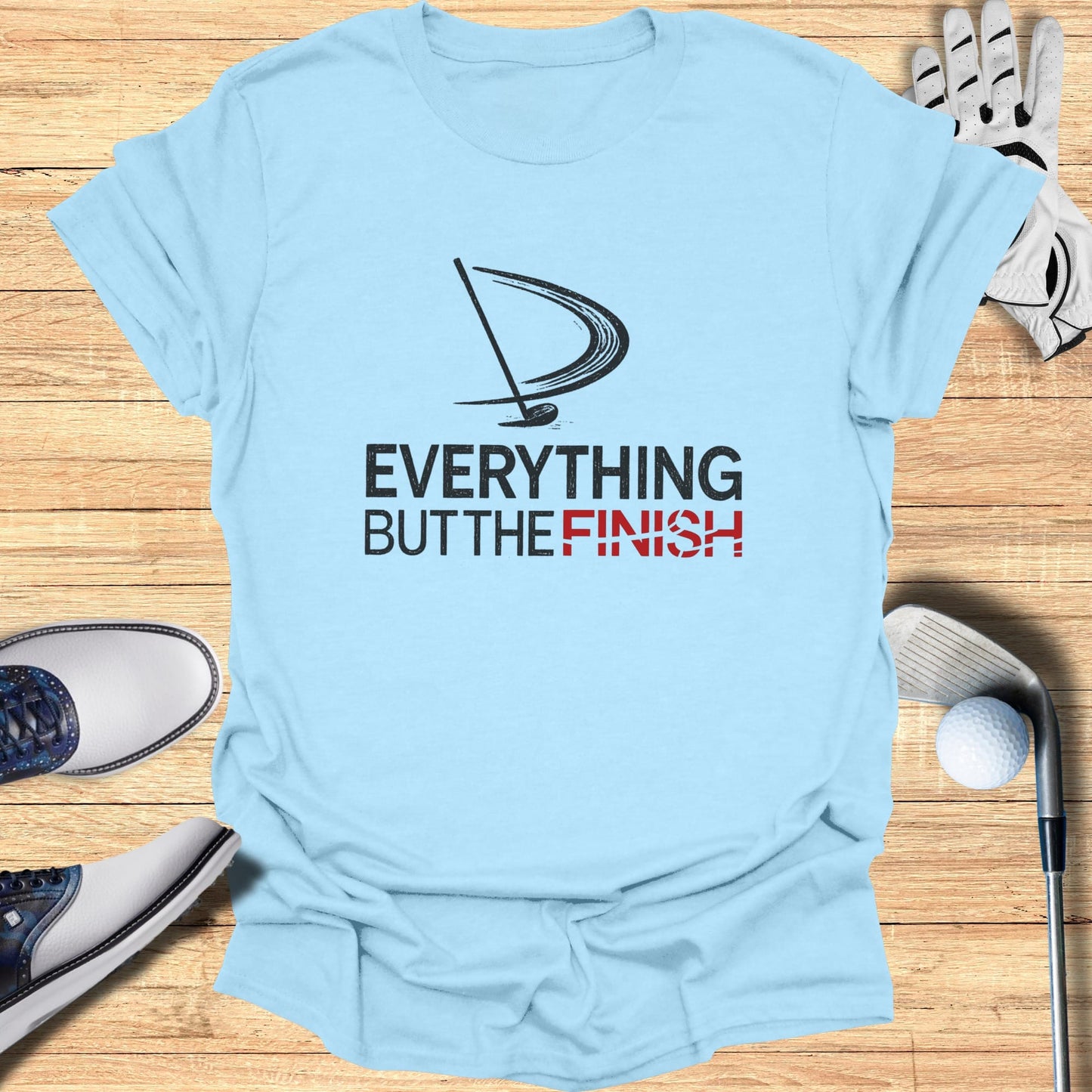 Light blue t-shirt with "EVERYTHING BUT THE FINISH" text and golf graphic.