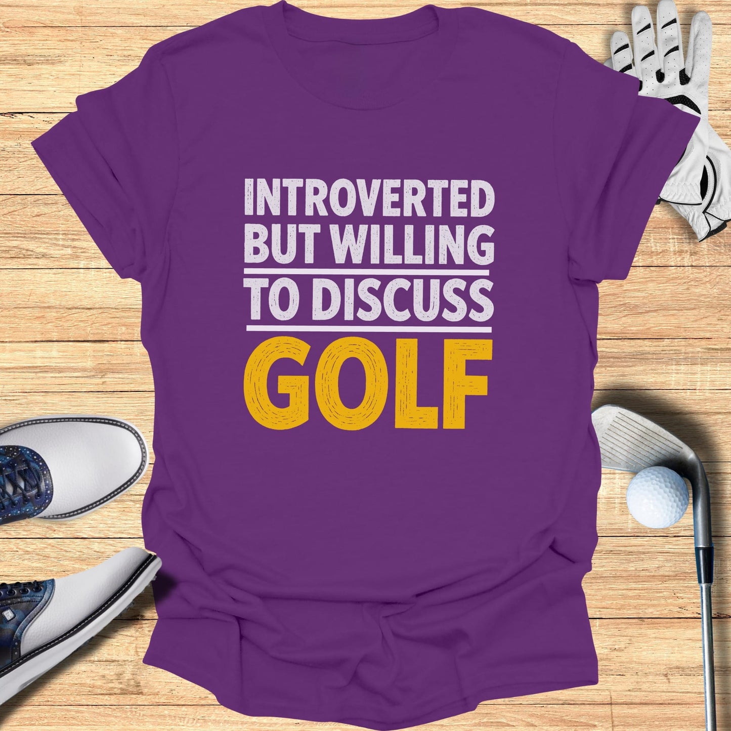 Purple t-shirt with "Introverted but willing to discuss golf" text in white and yellow.