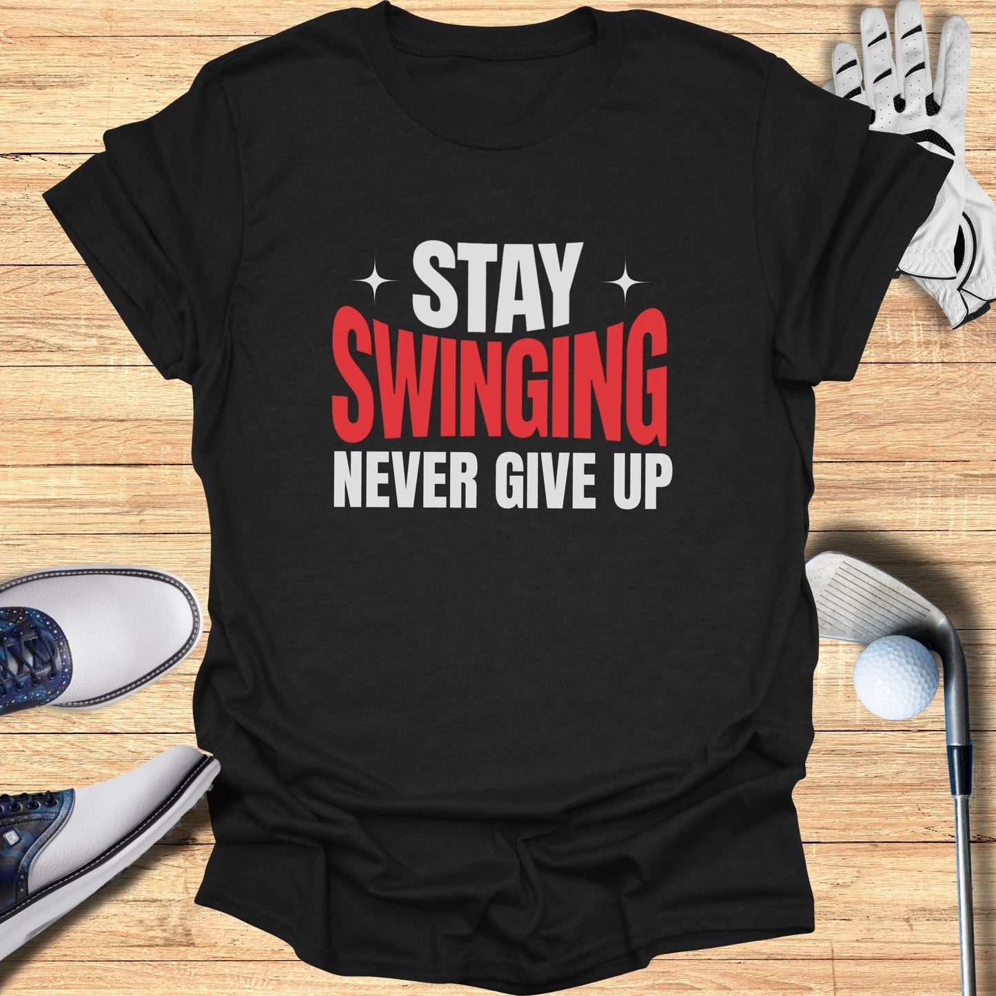 Black t-shirt with white and red text: "STAY SWINGING NEVER GIVE UP".