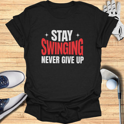 Black t-shirt with white and red text: "STAY SWINGING NEVER GIVE UP".