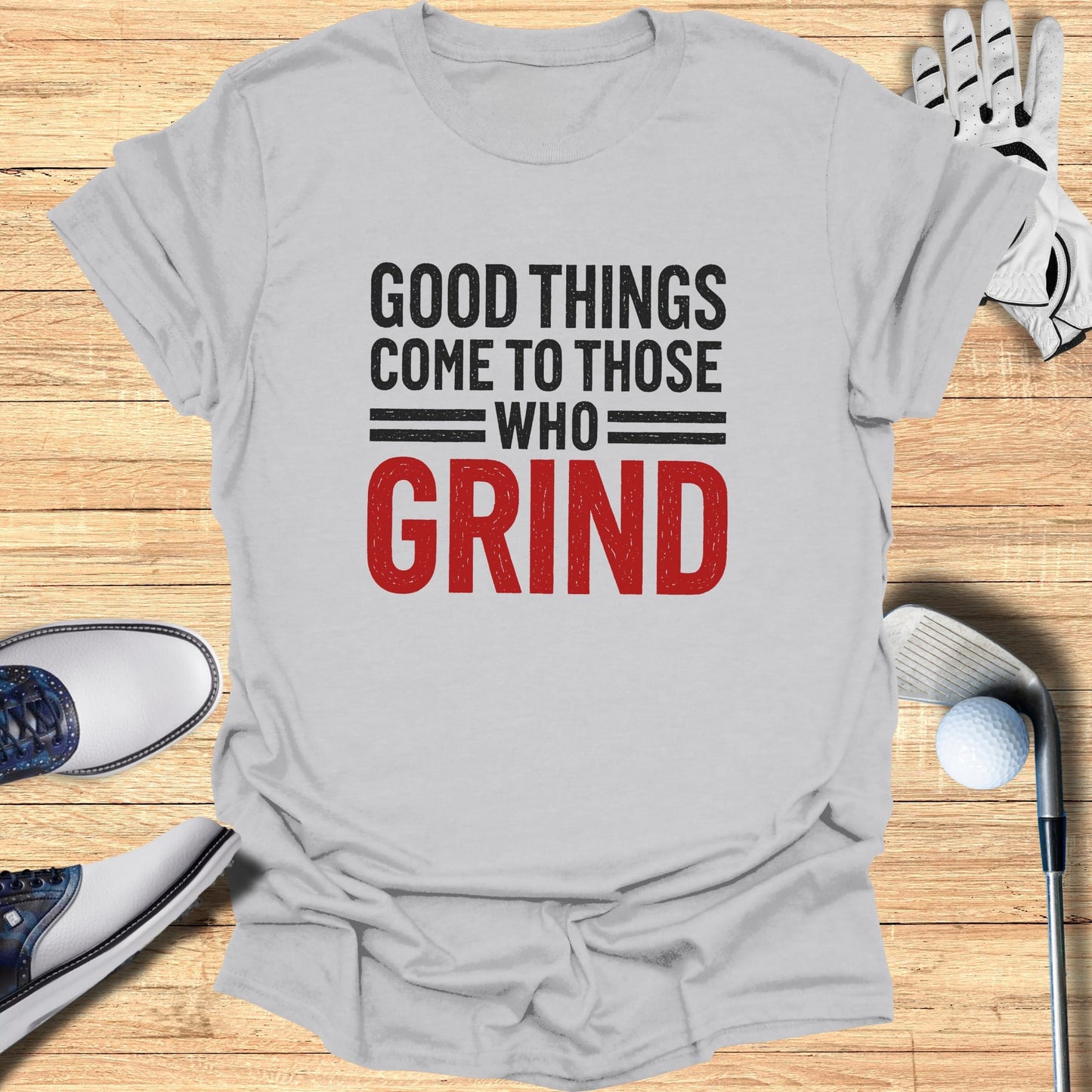 T-shirt with "Good Things Come to Those Who Grind" text, golf clubs, and shoes.