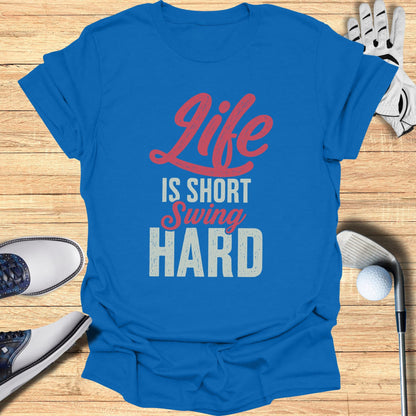 Blue t-shirt with "Life is Short Swing Hard" text and golf accessories.