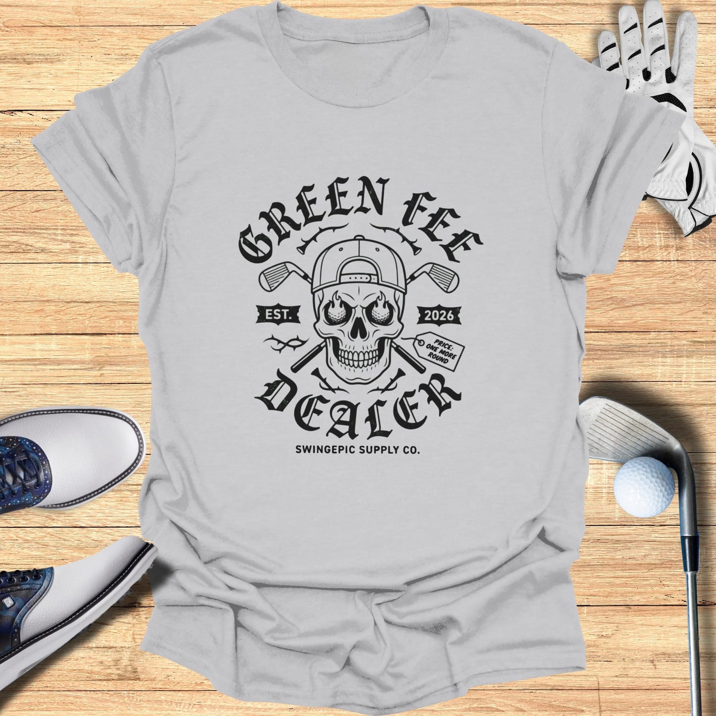 T-shirt with "Green Fee Dealer" skull graphic and "Swingepic Supply Co." text.