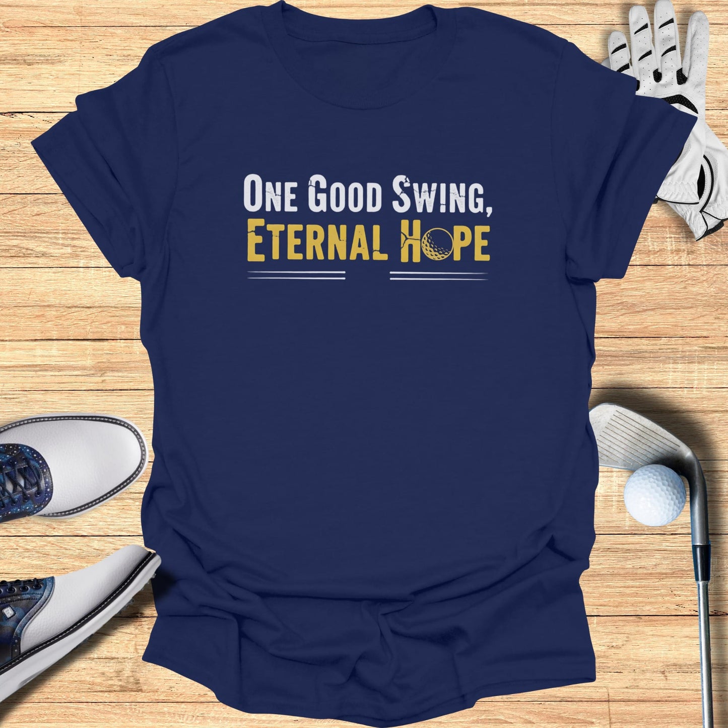 Navy t-shirt with "One Good Swing, Eternal Hope" and a golf ball.